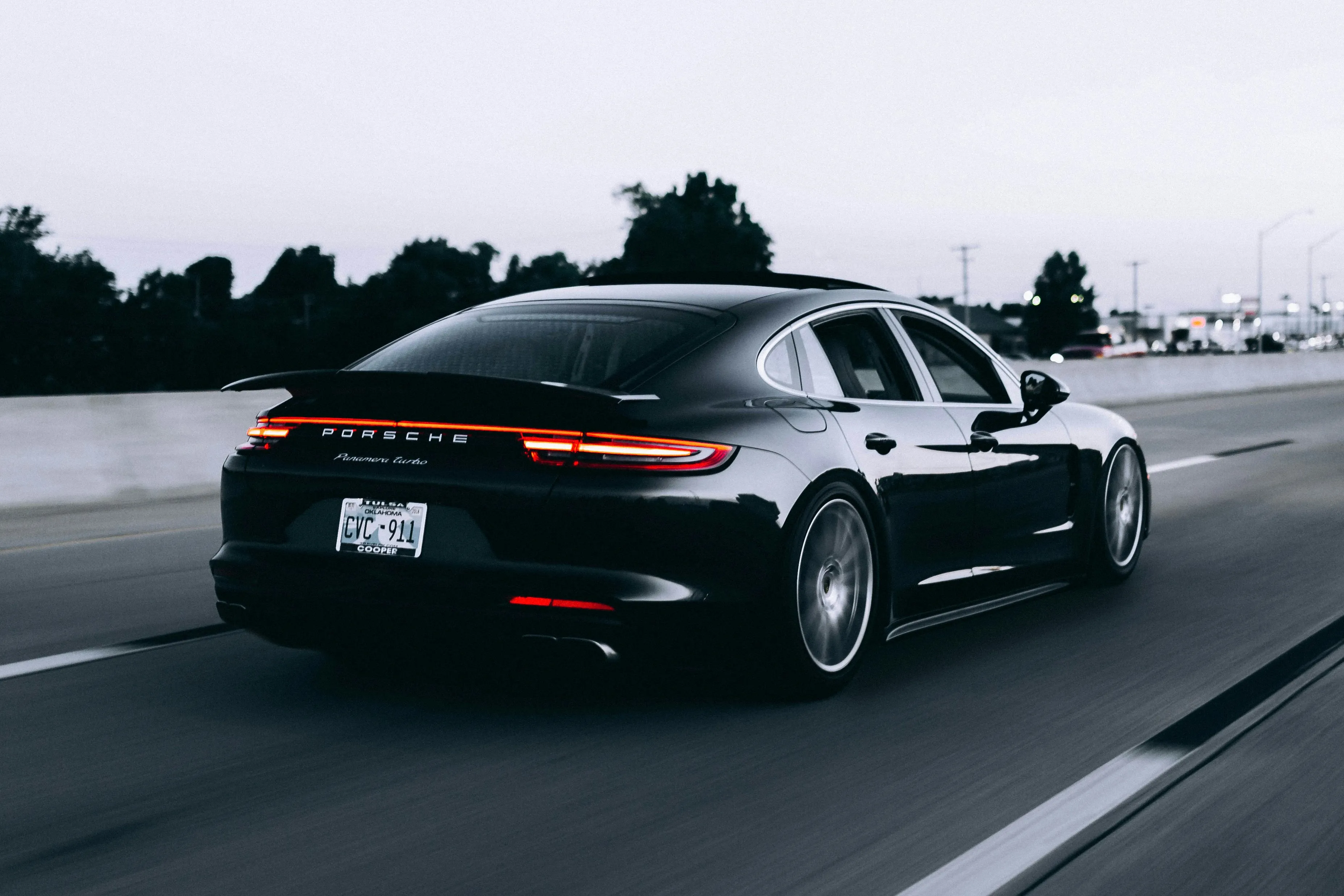 Dark grey performance sedan driving on a highway