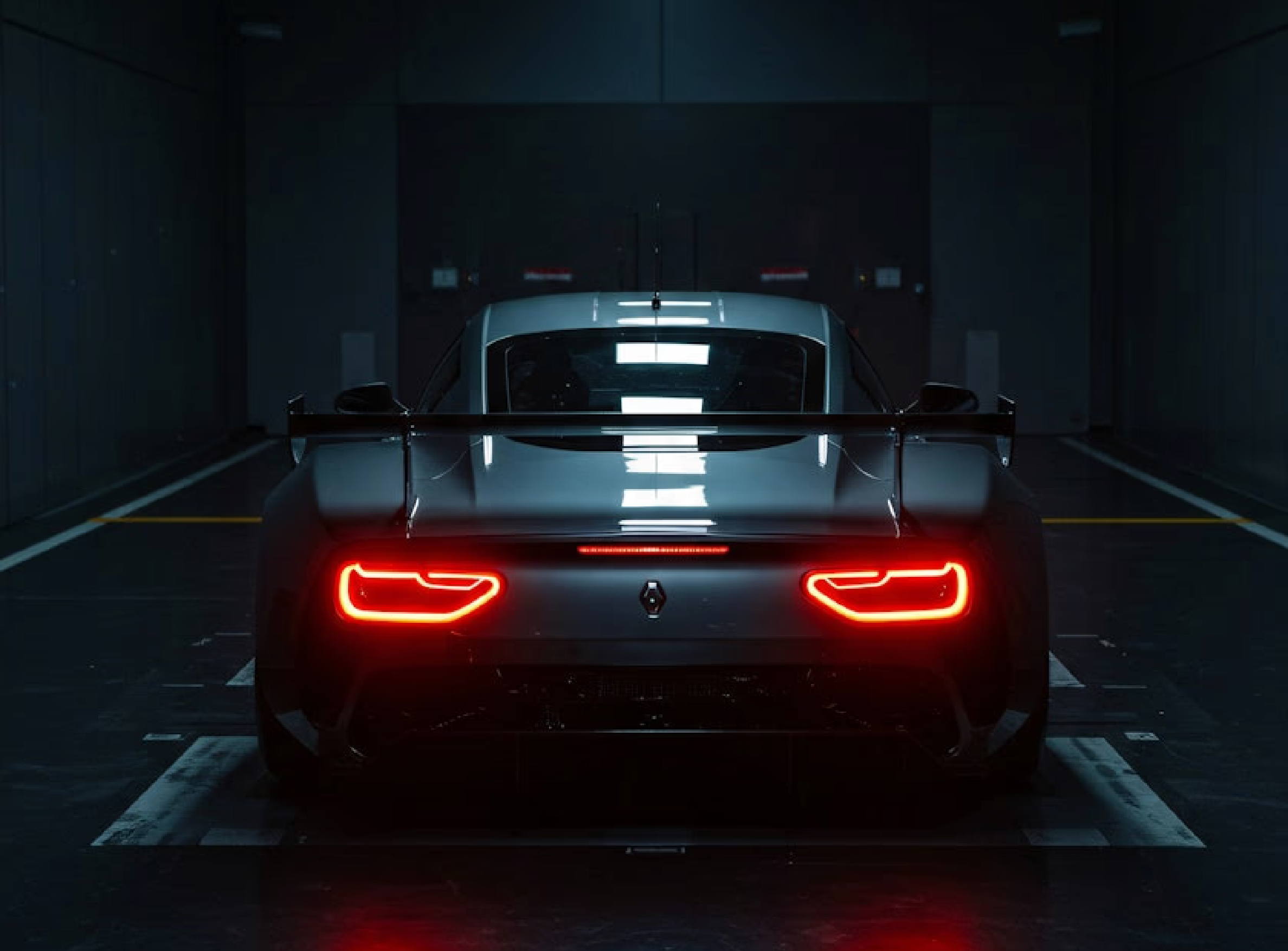 Rear view of a silver performance car with neon red